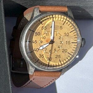 Men's watch featuring a cream-colored dial, brown band